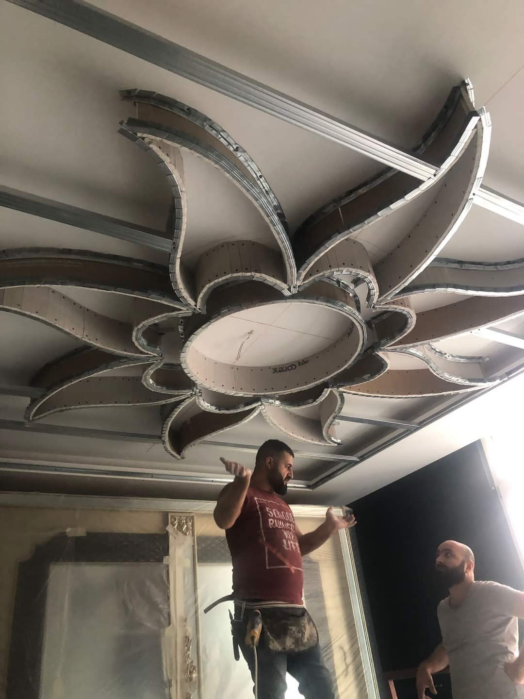 Decorative flower ceiling medallion being installed
